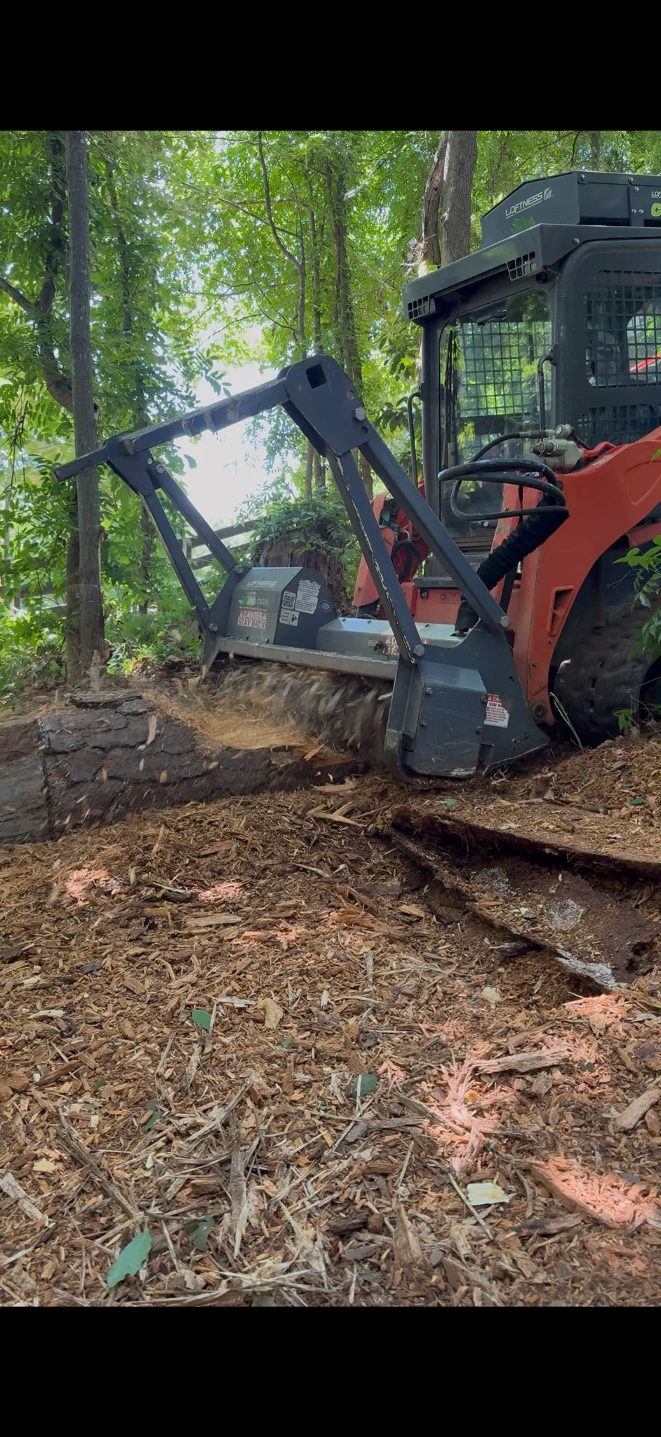 Kubota forestry mulcher working around a stump